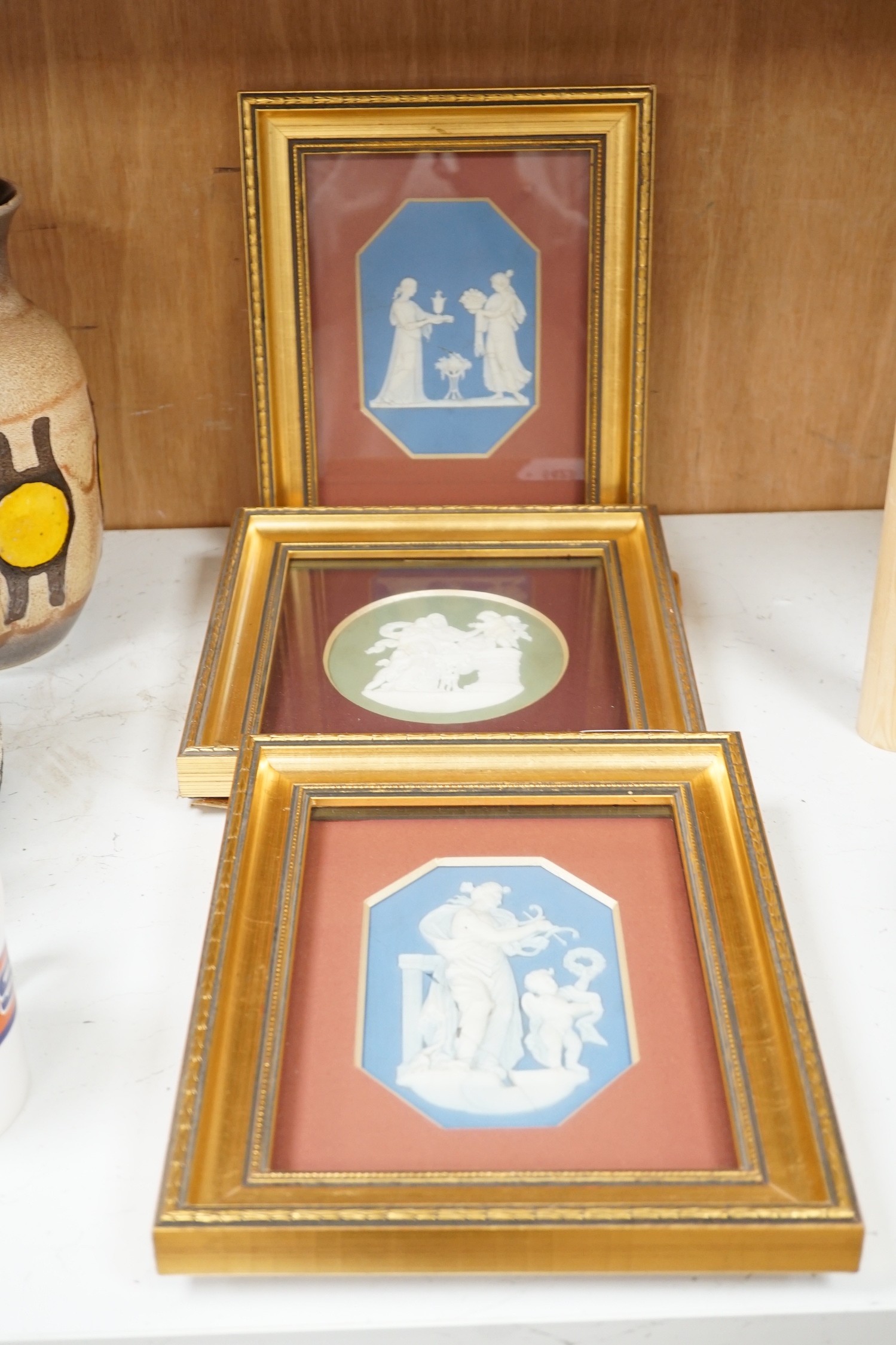 Three framed Wedgwood Jasper ware plaques (one cracked), largest 14.5cms high